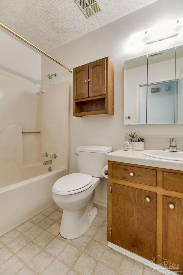 8500 Blue Jay Way, Pensacola, FL 32534 - bathroom with toilet, vanity, shower / washtub combination, tile patterned floors, and a textured ceiling