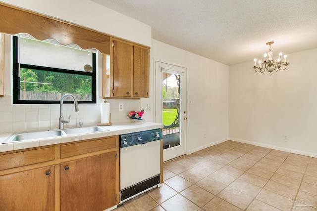 8500 Blue Jay Way, Pensacola, FL 32534 - kitchen with white dishwasher, a sink, a chandelier, light tile patterned flooring, and tile counters