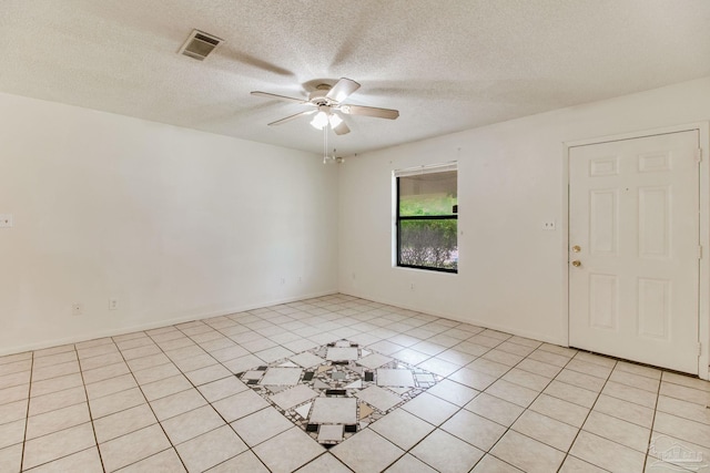 8500 Blue Jay Way, Pensacola, FL 32534 - empty room with a ceiling fan, a textured ceiling, and light tile patterned floors
