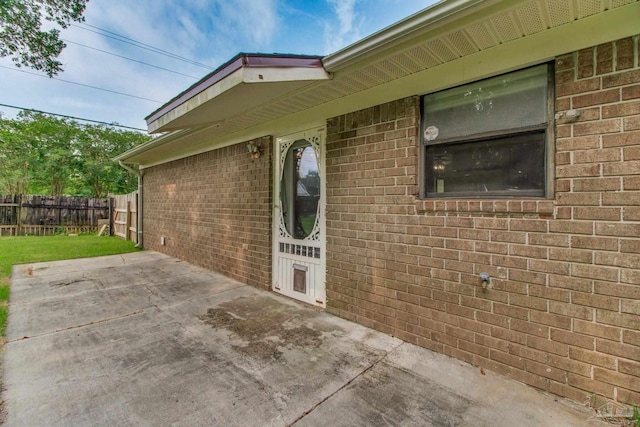 8500 Blue Jay Way, Pensacola, FL 32534 - doorway to property with a patio and brick siding