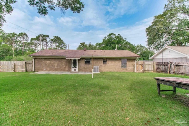 8500 Blue Jay Way, Pensacola, FL 32534 - back of house featuring a patio, brick siding, and a shingled roof
