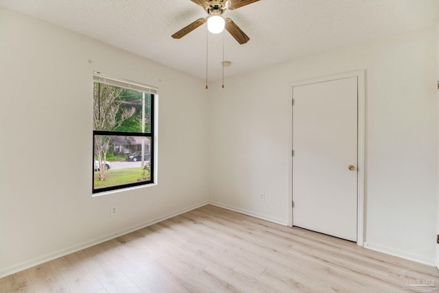 8500 Blue Jay Way, Pensacola, FL 32534 - spare room featuring light wood-type flooring, ceiling fan, baseboards, and a textured ceiling