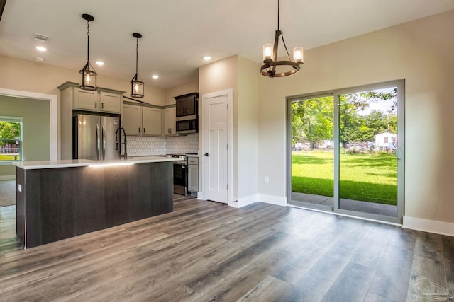 205 Webb St, Cantonment, FL 32533 - kitchen with appliances with stainless steel finishes, light countertops, baseboards, backsplash, and a chandelier