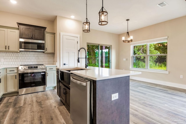 205 Webb St, Cantonment, FL 32533 - kitchen with appliances with stainless steel finishes, a sink, light countertops, backsplash, and light wood-style floors