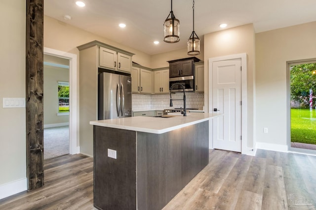 205 Webb St, Cantonment, FL 32533 - kitchen featuring stainless steel appliances, light countertops, tasteful backsplash, wood finished floors, and baseboards