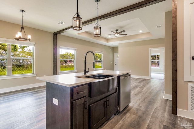 205 Webb St, Cantonment, FL 32533 - kitchen featuring stainless steel dishwasher, wood finished floors, light countertops, a sink, and dark brown cabinets