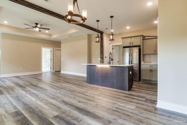 205 Webb St, Cantonment, FL 32533 - kitchen featuring freestanding refrigerator, gray cabinetry, a center island with sink, open floor plan, and baseboards