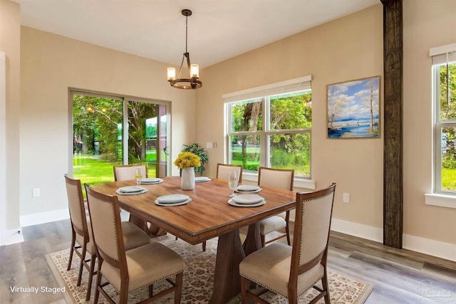 205 Webb St, Cantonment, FL 32533 - dining area with a chandelier, wood finished floors, and baseboards