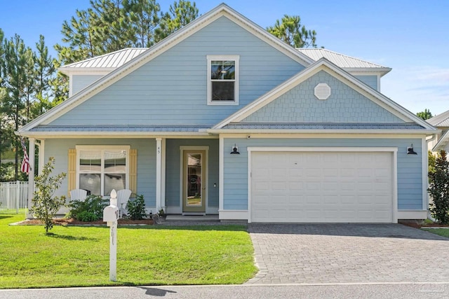 view of front of house with a garage and a front lawn