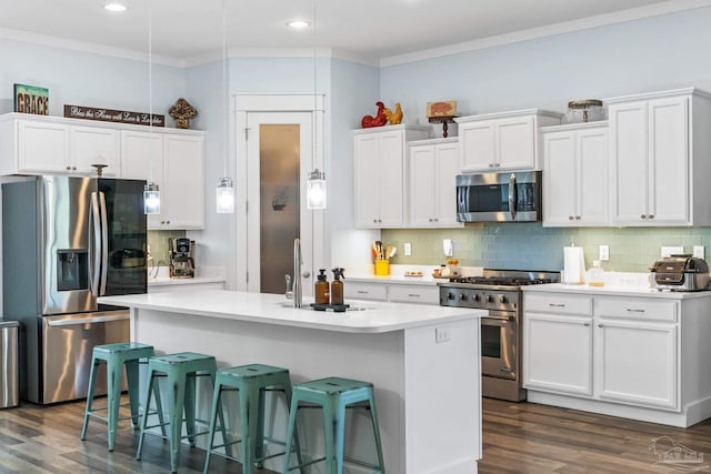 kitchen featuring an island with sink, dark wood-type flooring, stainless steel appliances, and white cabinets