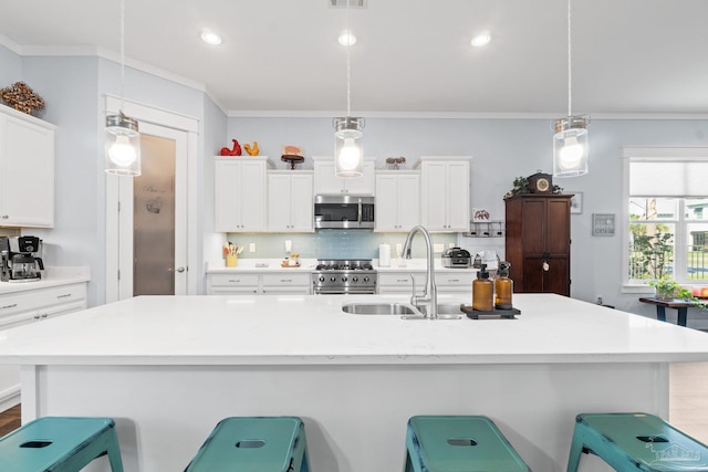 kitchen featuring a kitchen breakfast bar, stainless steel appliances, and decorative light fixtures