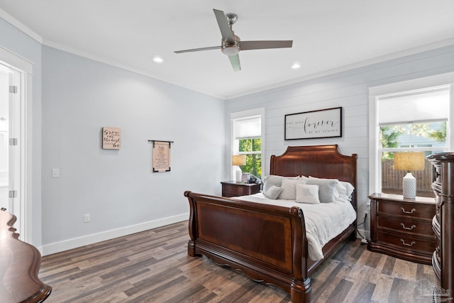 bedroom with ceiling fan, ornamental molding, wood walls, and dark wood-type flooring