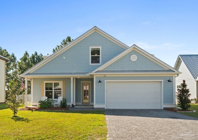 view of front of home with a front yard, a garage, and covered porch