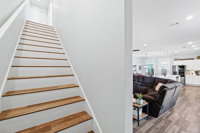 stairway featuring hardwood / wood-style floors