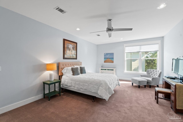 bedroom with ceiling fan, dark carpet, and a wall mounted AC