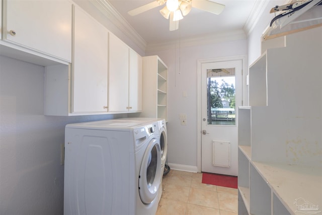 clothes washing area with light tile patterned flooring, cabinets, ornamental molding, and washer and dryer