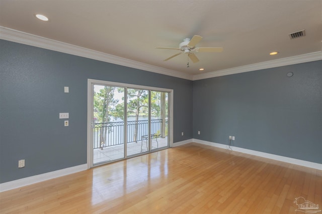 empty room featuring crown molding, ceiling fan, and light wood-type flooring