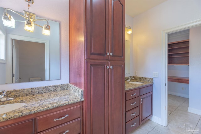 bathroom featuring tile patterned floors, toilet, and vanity