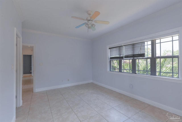 tiled spare room featuring crown molding and ceiling fan