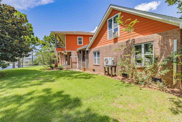 back of property featuring a lawn and ac unit