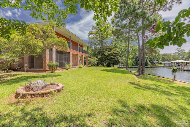 view of yard with a balcony and a water view