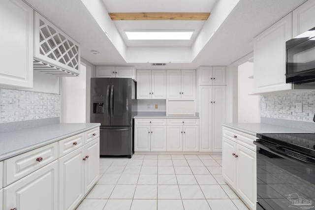 kitchen featuring black appliances and white cabinetry