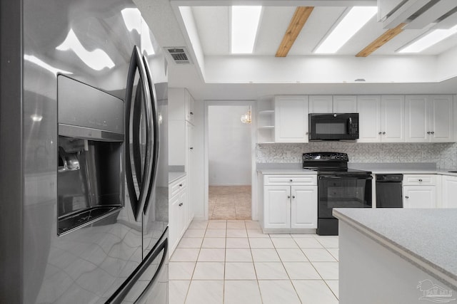 kitchen featuring black appliances, white cabinetry, and light tile patterned flooring