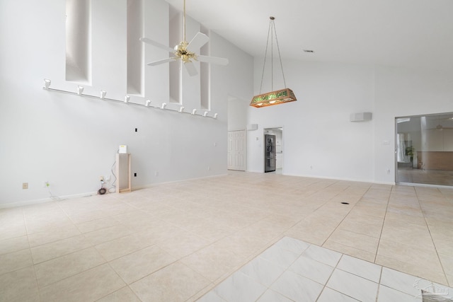 unfurnished living room featuring ceiling fan, light tile patterned floors, and high vaulted ceiling