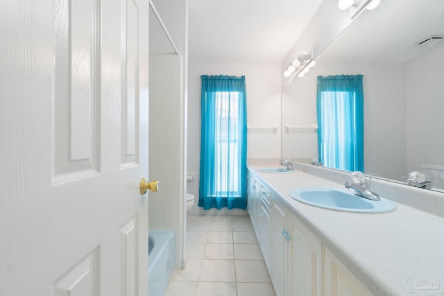 bathroom featuring a tub to relax in, vanity, toilet, and tile patterned floors