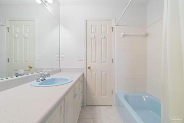 bathroom with vanity, tiled shower / bath, and tile patterned floors