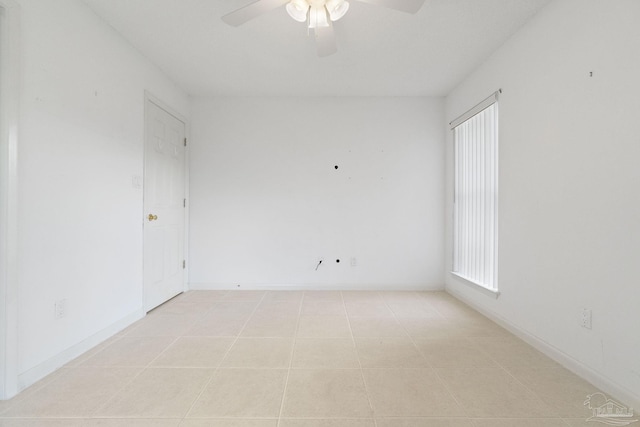 empty room featuring ceiling fan and light tile patterned floors