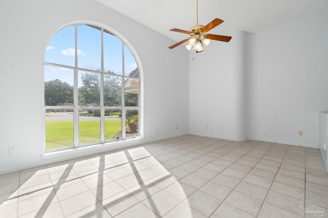 unfurnished room with ceiling fan and light tile patterned flooring