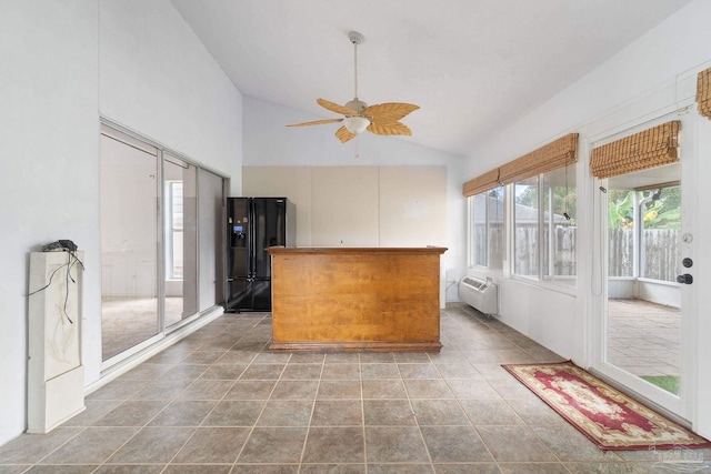 kitchen with high vaulted ceiling, a wall unit AC, black fridge with ice dispenser, tile patterned flooring, and ceiling fan