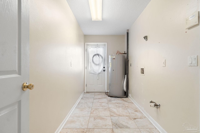 doorway featuring a textured ceiling and electric water heater