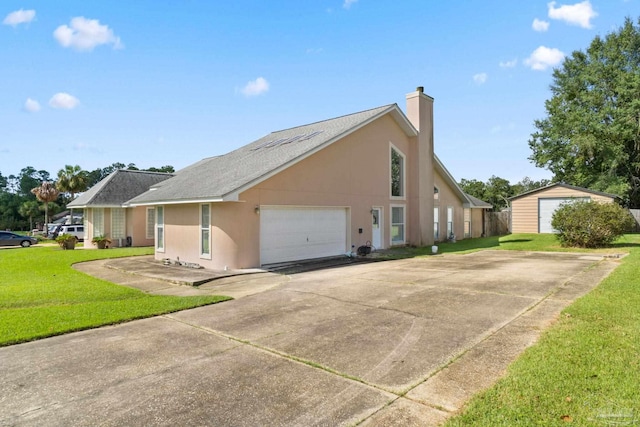 view of front of house with a garage and a front lawn