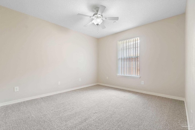 carpeted empty room with a textured ceiling and ceiling fan