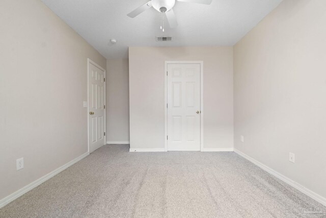 empty room with carpet and ceiling fan