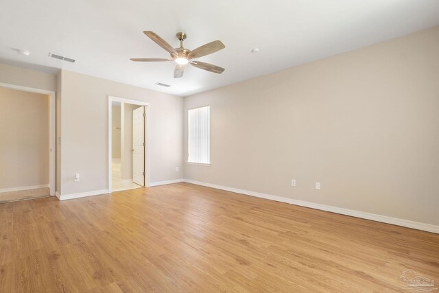 interior space featuring light hardwood / wood-style flooring, ensuite bathroom, and ceiling fan