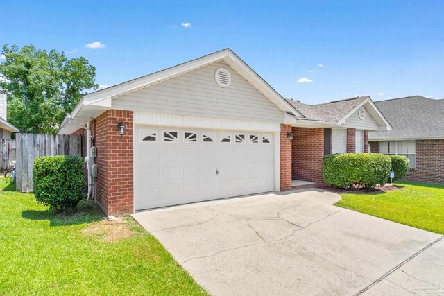 ranch-style home featuring a garage and a front lawn