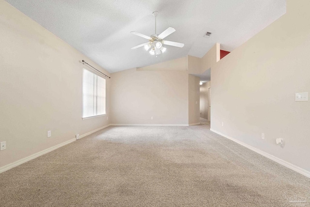 carpeted spare room featuring lofted ceiling and ceiling fan