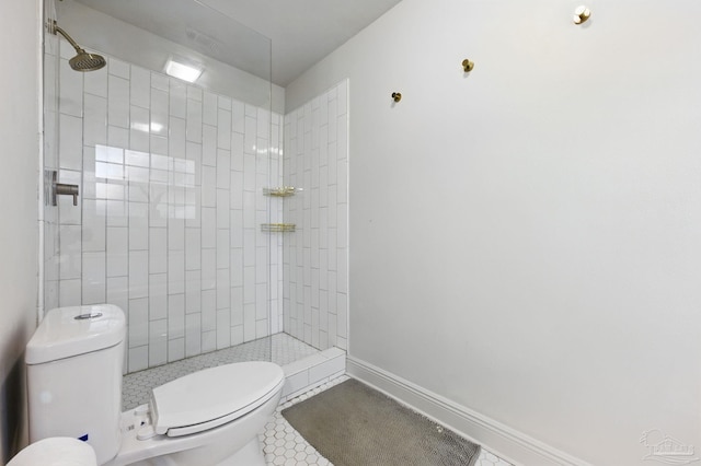 4793 Coronado Cir, Crestview, FL 32539 - bathroom featuring toilet, tiled shower, tile patterned flooring, and baseboards
