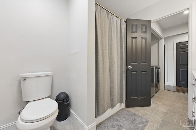 4793 Coronado Cir, Crestview, FL 32539 - full bath with toilet, washer / dryer, curtained shower, baseboards, and tile patterned flooring