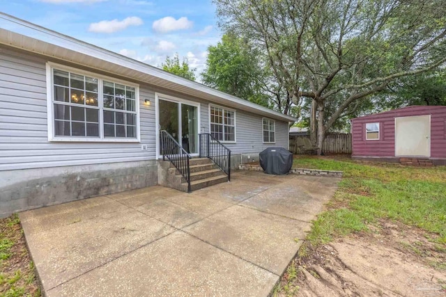 4793 Coronado Cir, Crestview, FL 32539 - rear view of property featuring a patio area, fence, a storage unit, an outdoor structure, and entry steps