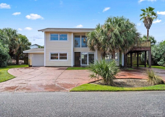 view of front of property with concrete driveway and a garage