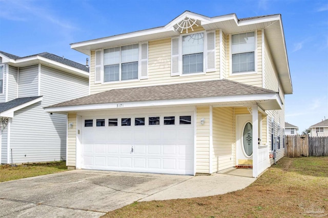 view of front of property featuring a garage and a front yard