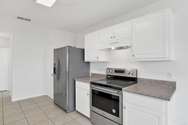 kitchen featuring white cabinetry, stainless steel appliances, and light tile patterned flooring