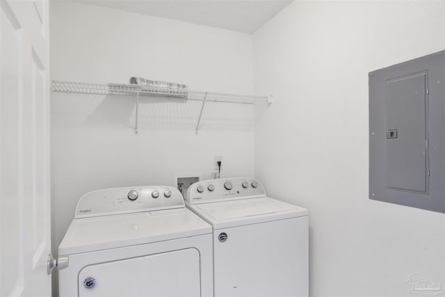 washroom with electric panel and washer and dryer