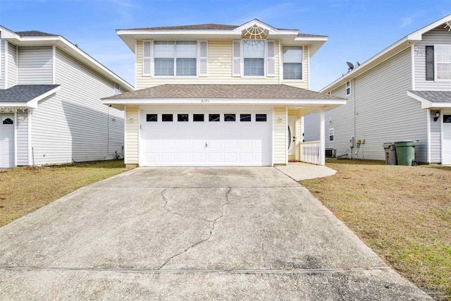 view of property with a garage and a front yard