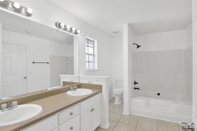 full bathroom featuring shower / tub combination, vanity, toilet, tile patterned floors, and a textured ceiling