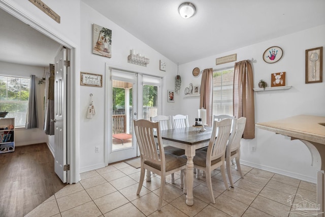 80 Woodland St, Cantonment, FL 32533 - dining room with vaulted ceiling, healthy amount of natural light, baseboards, and light tile patterned floors